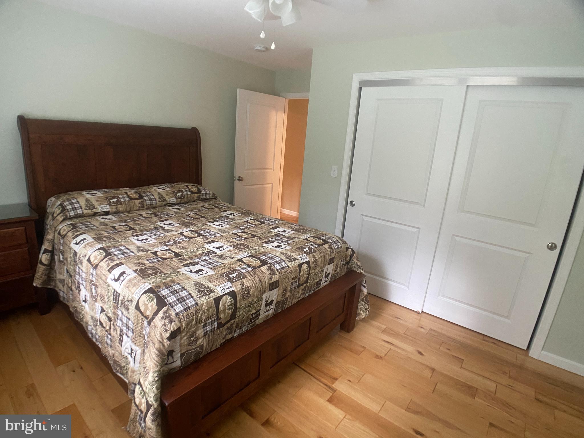 4740 Ford Fields Road Myersville, MD 21773 - Photo 67 of 147 a bedroom with a bed and wooden floor