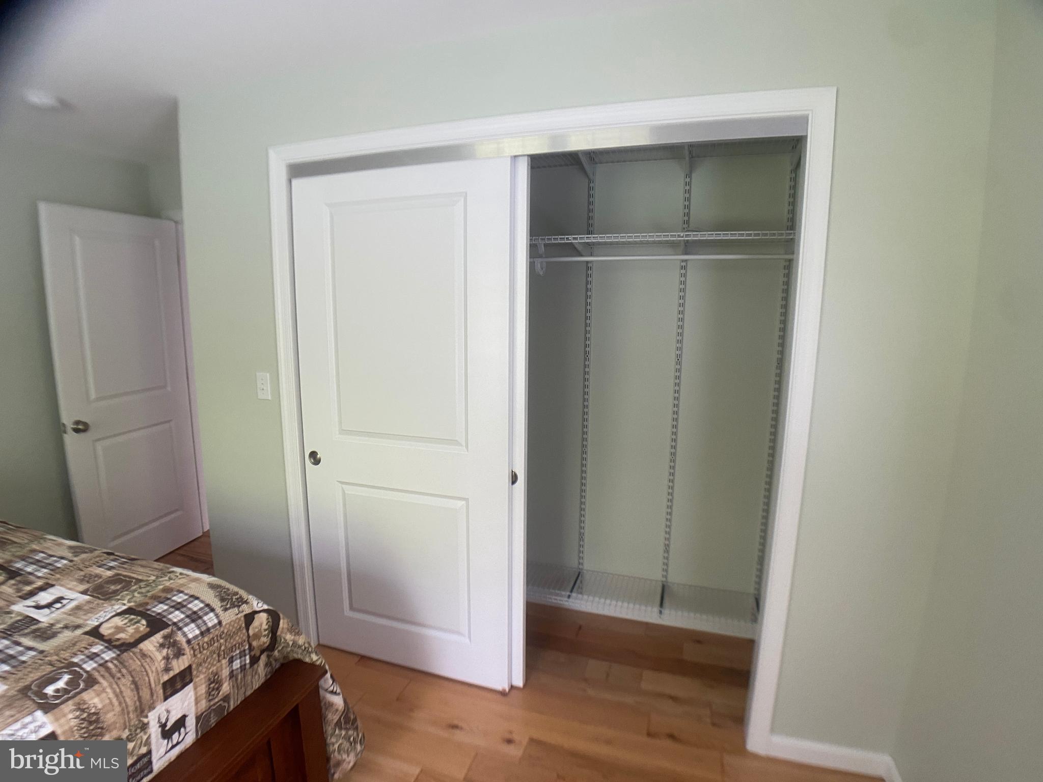 4740 Ford Fields Road Myersville, MD 21773 - Photo 69 of 147 a bedroom with a bed and wooden floor