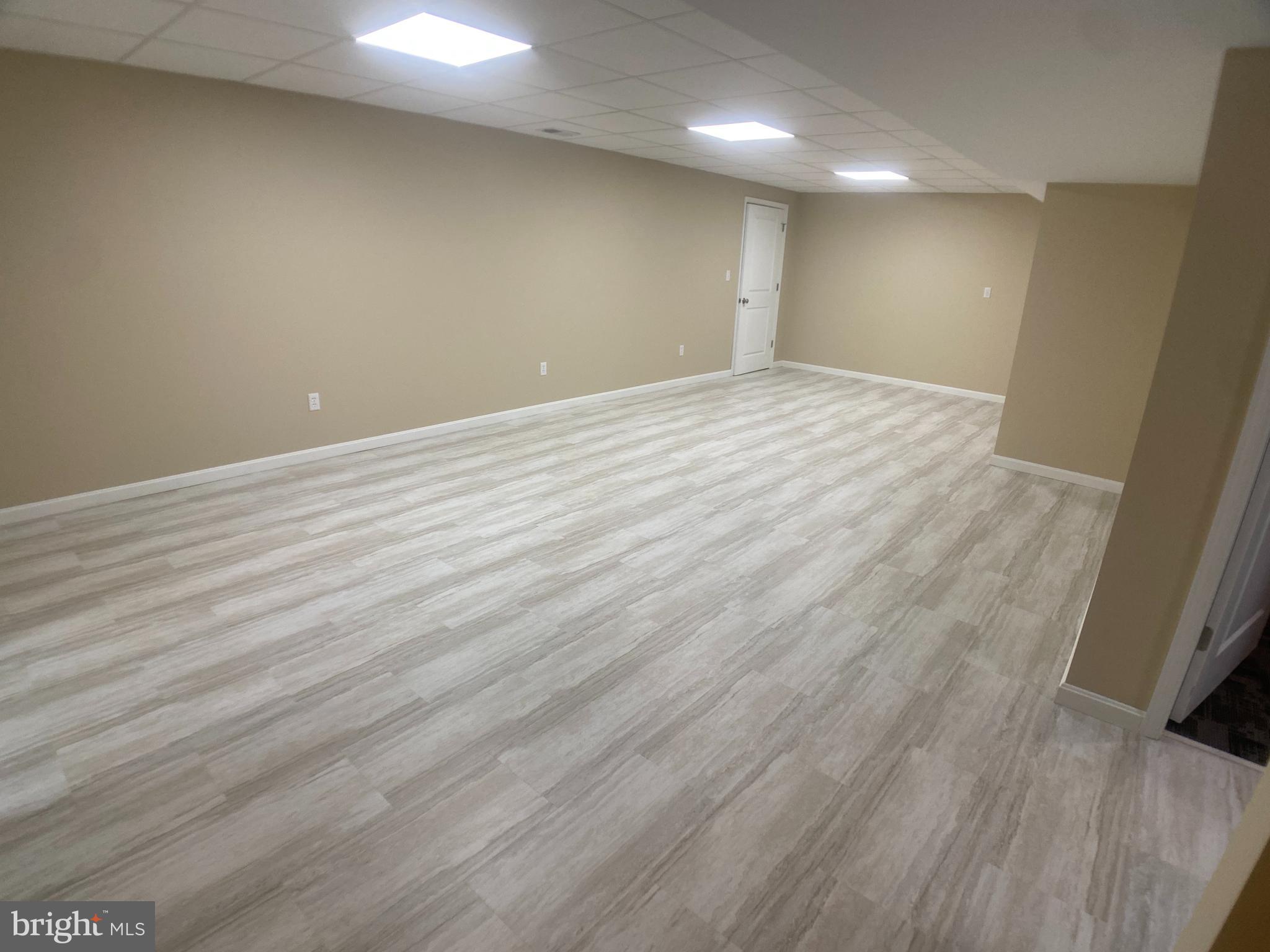 4740 Ford Fields Road Myersville, MD 21773 - Photo 80 of 147 an empty room with wooden floor and windows