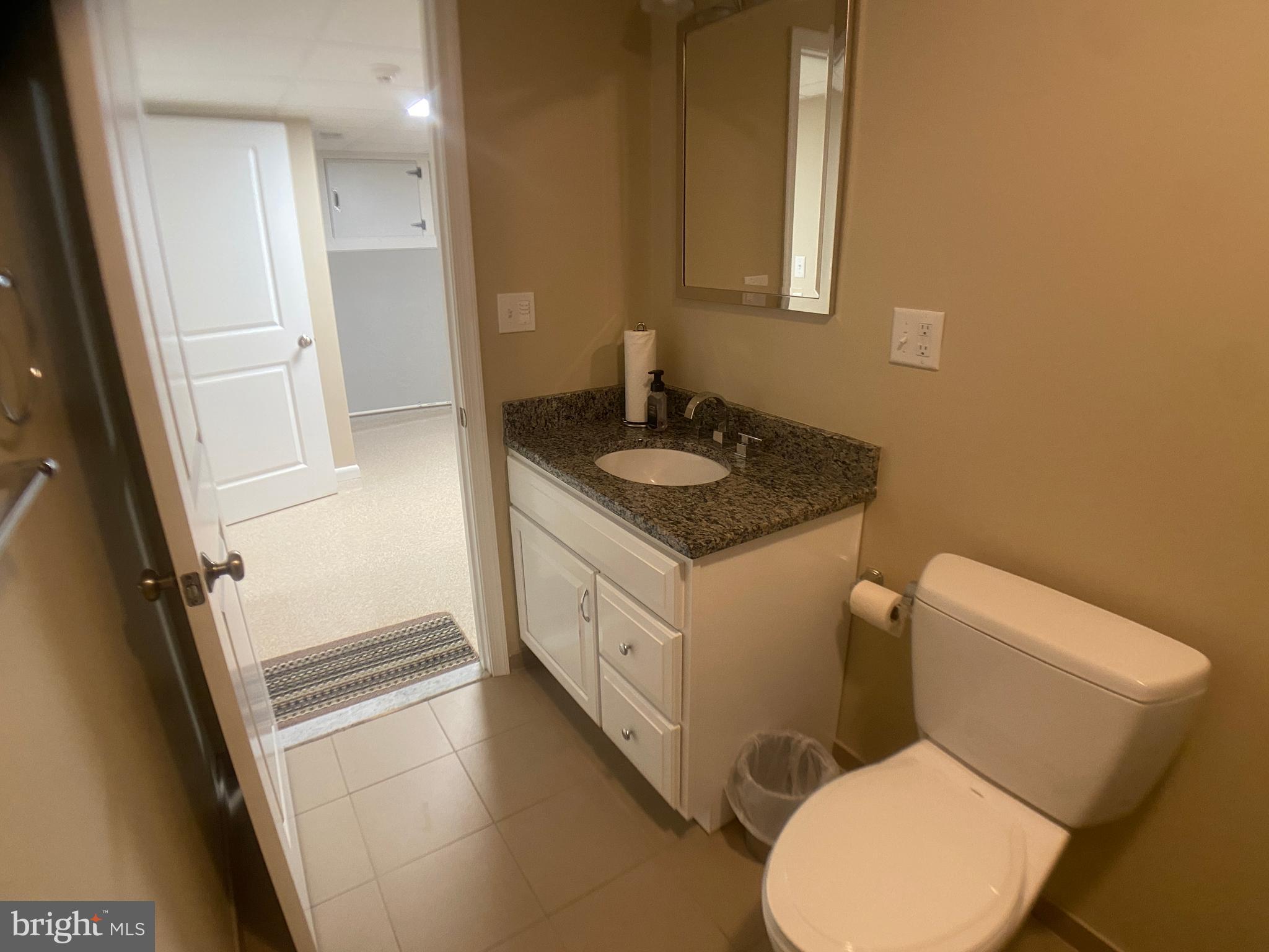 4740 Ford Fields Road Myersville, MD 21773 - Photo 82 of 147 a bathroom with a granite countertop toilet sink and mirror