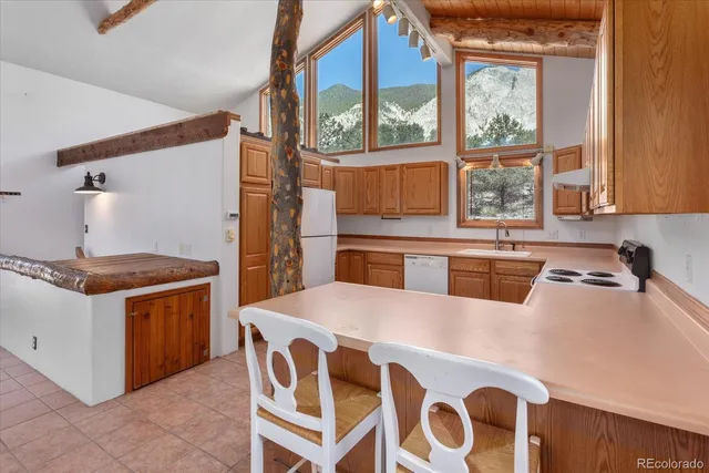 a kitchen with a stove a sink and a refrigerator