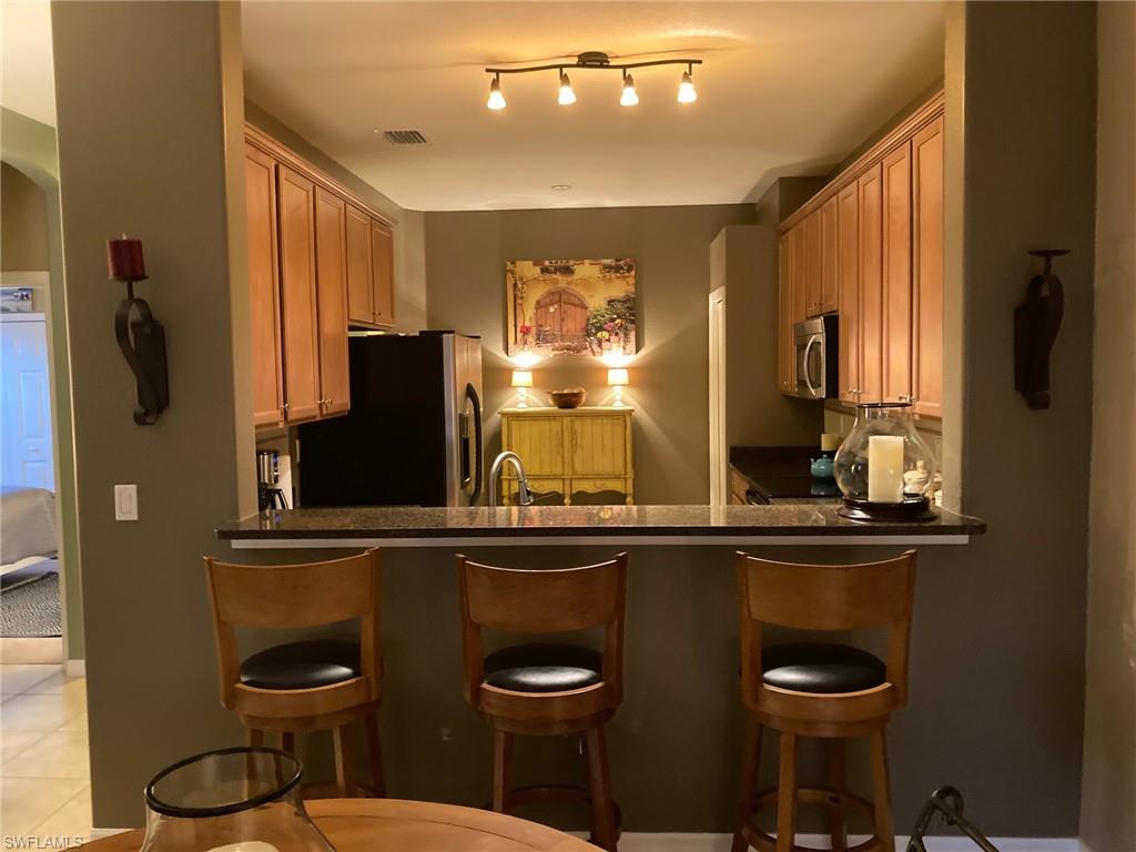 21334 Bella Terra Boulevard Estero, FL 33928 - Photo 11 of 30 a kitchen with a table and chairs in it