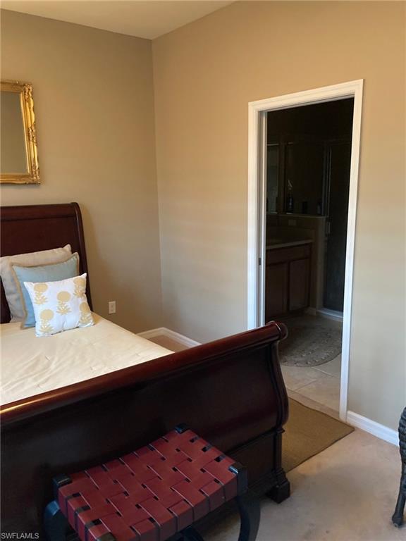 21334 Bella Terra Boulevard Estero, FL 33928 - Photo 17 of 30 a bed room with a bed and a night stand
