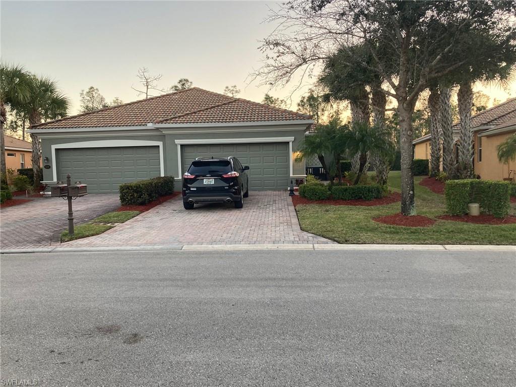 21334 Bella Terra Boulevard Estero, FL 33928 - Photo 2 of 30 a view of a car parked in front of house