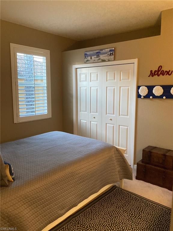 21334 Bella Terra Boulevard Estero, FL 33928 - Photo 21 of 30 a bedroom with a bed and wooden floor