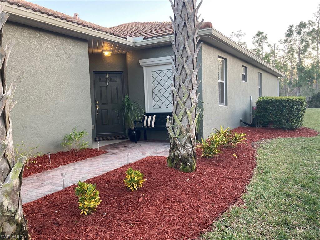 21334 Bella Terra Boulevard Estero, FL 33928 - Photo 3 of 30 a front view of a house with garden