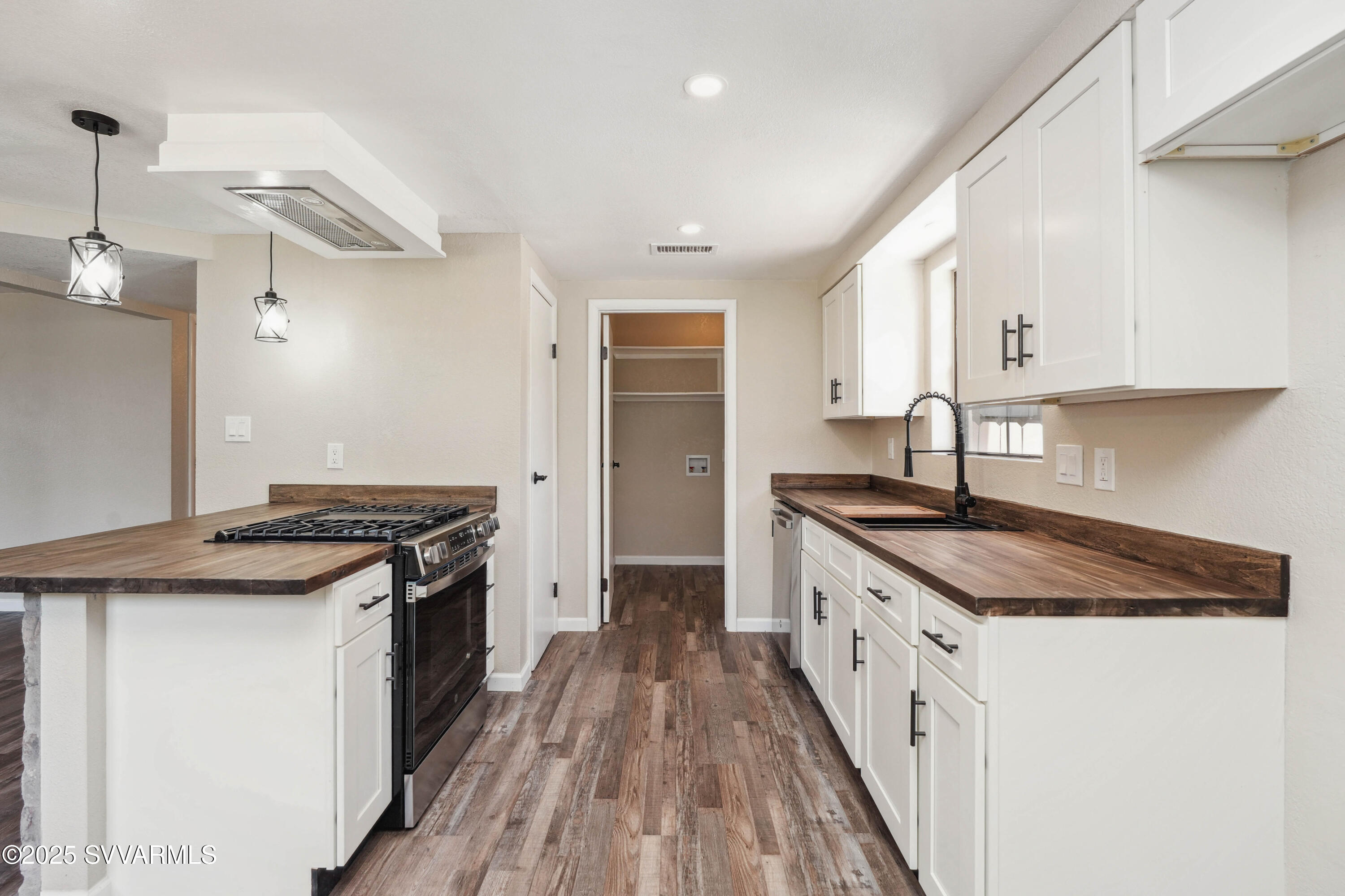 248 South River Cave Road Camp Verde, AZ 86322 - Photo 11 of 36 a kitchen with granite countertop a sink stove and cabinets