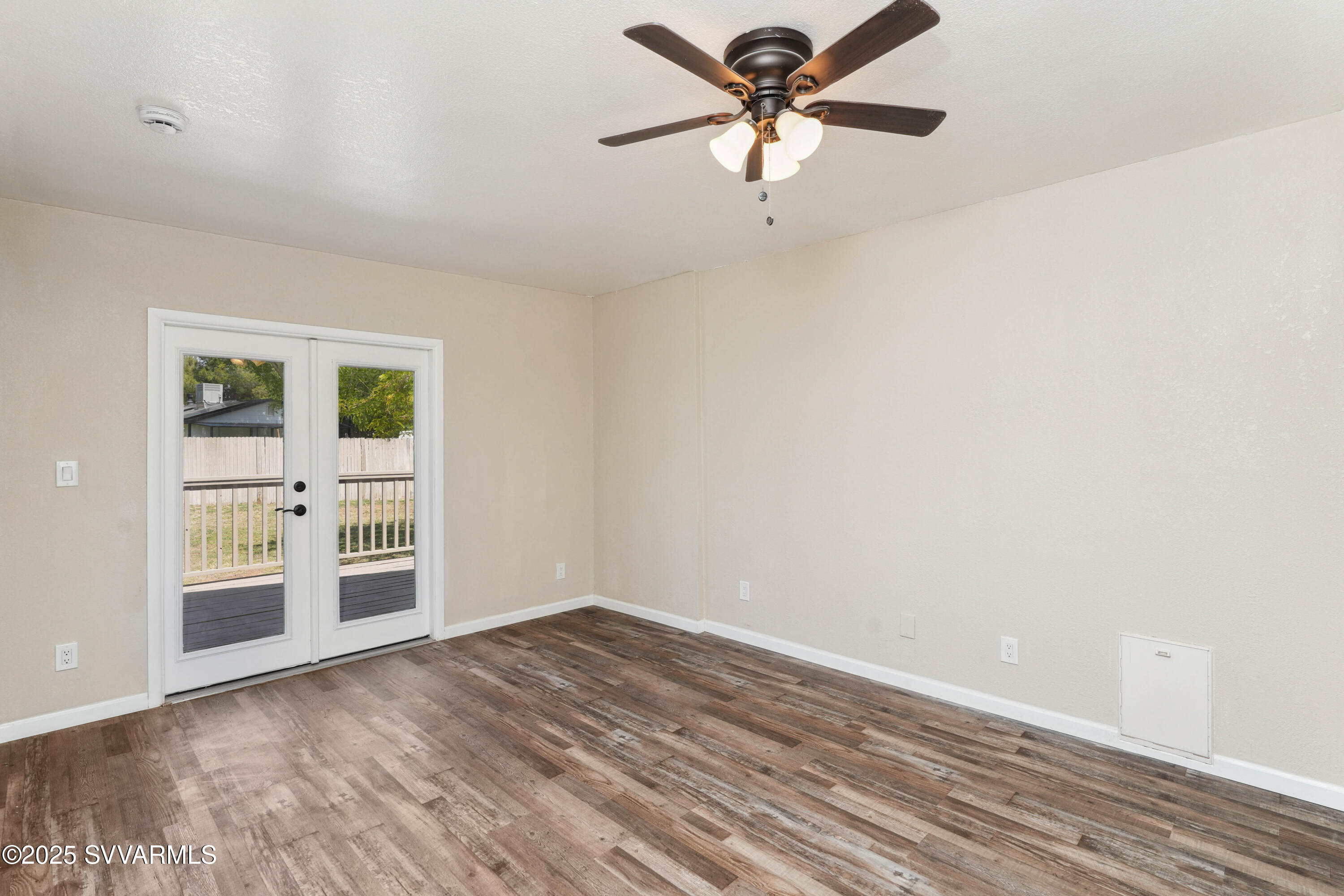 248 South River Cave Road Camp Verde, AZ 86322 - Photo 12 of 36 wooden floor in an empty room with a window