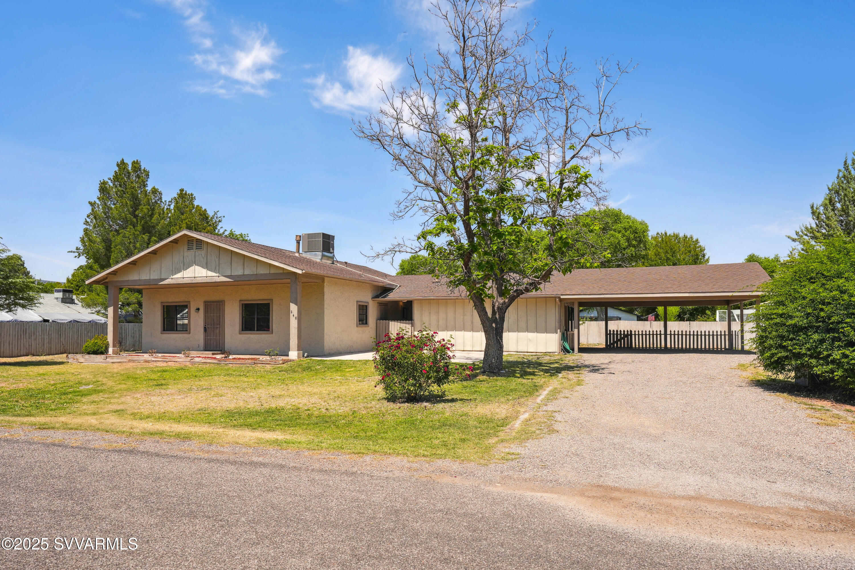 248 South River Cave Road Camp Verde, AZ 86322 - Photo 2 of 36 a white house with a big yard and large trees