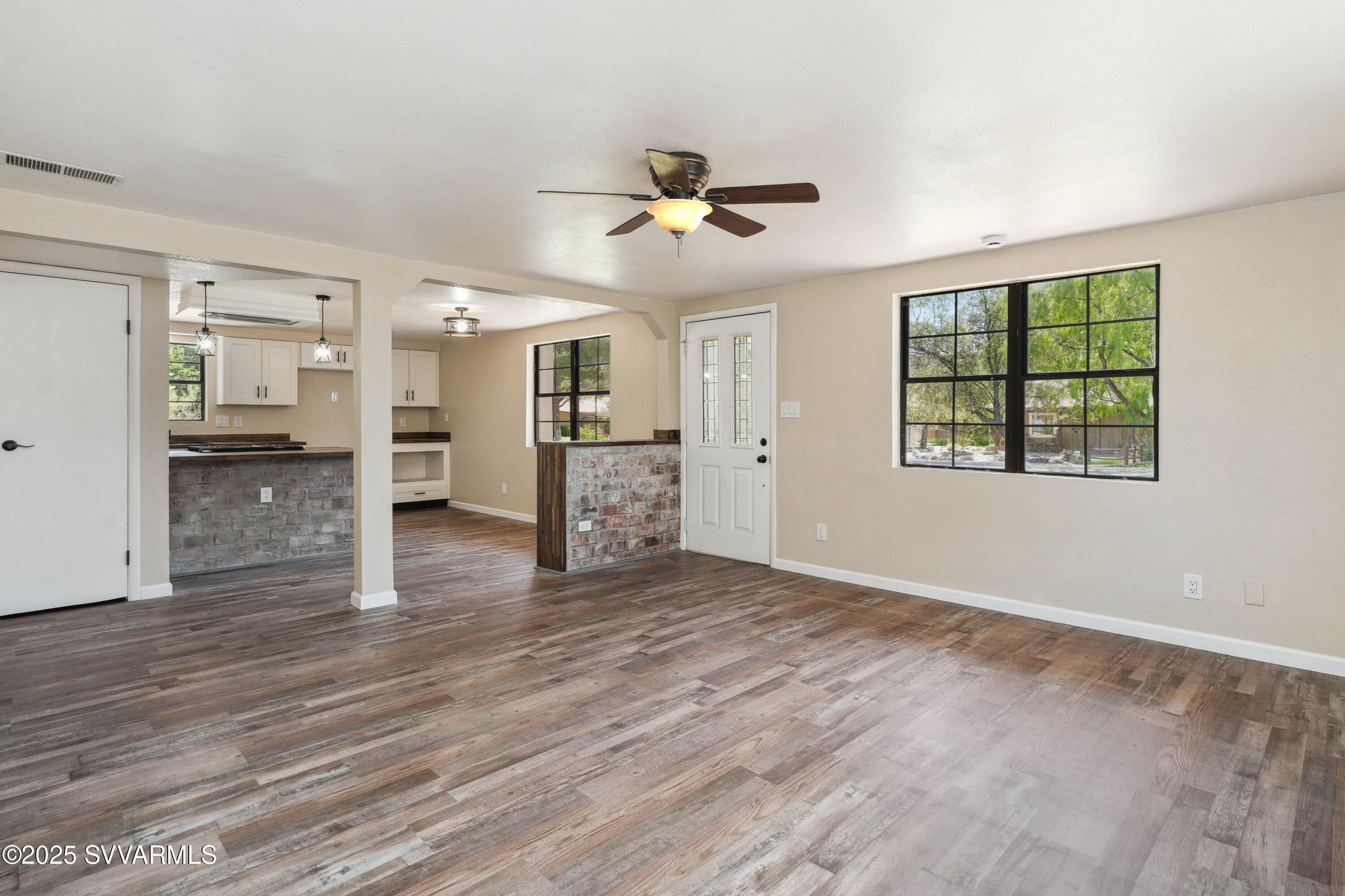 248 South River Cave Road Camp Verde, AZ 86322 - Photo 4 of 36 a view of a kitchen with a stove cabinets a ceiling fan and wooden floor