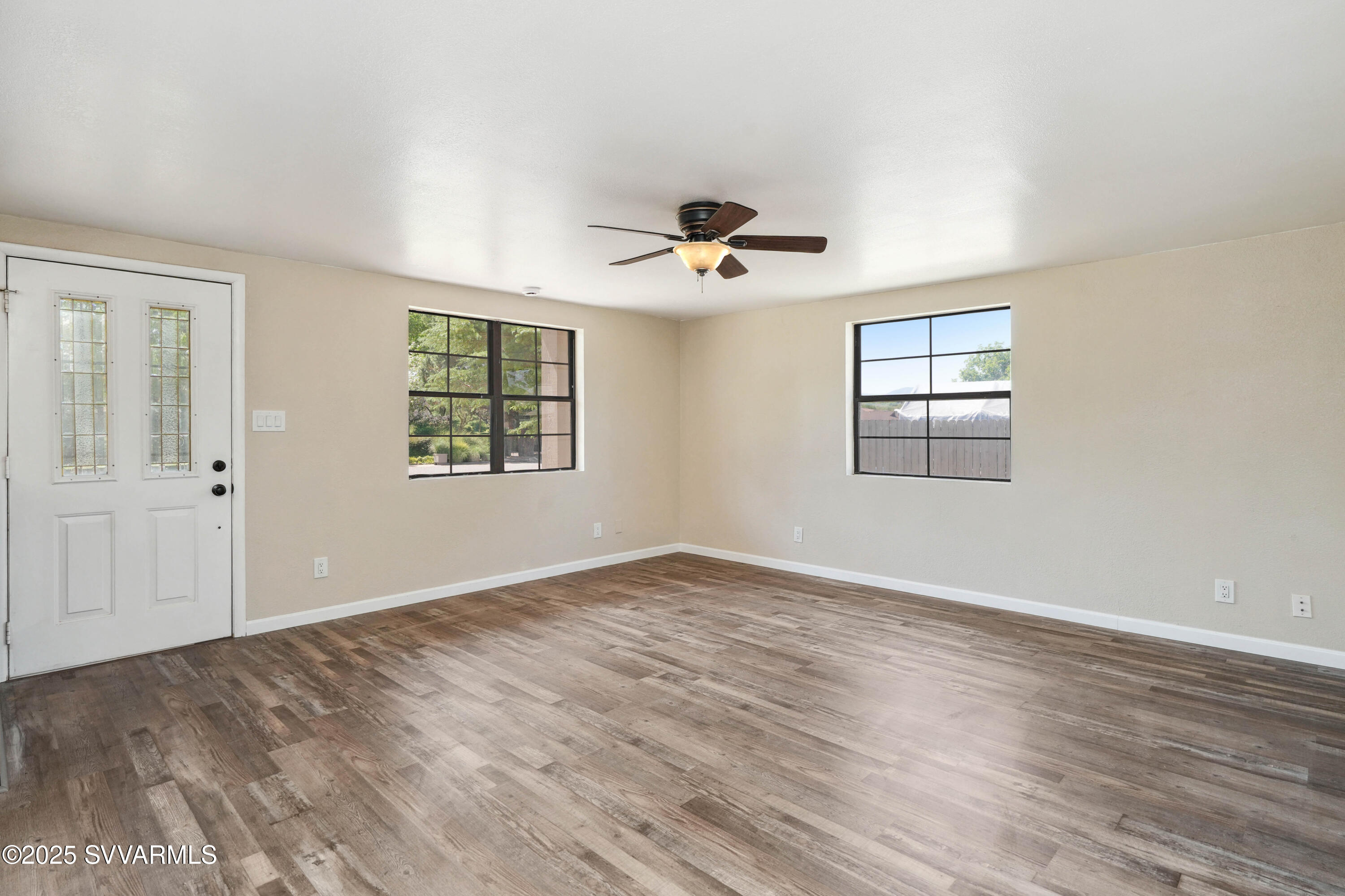 248 South River Cave Road Camp Verde, AZ 86322 - Photo 5 of 36 wooden floor in an empty room with a window