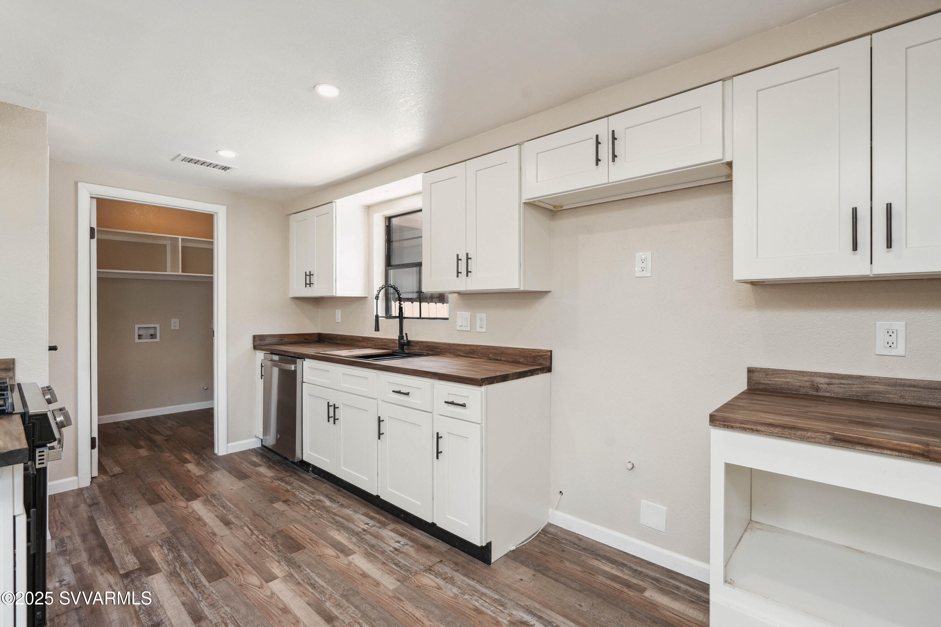 248 South River Cave Road Camp Verde, AZ 86322 - Photo 10 of 36 a kitchen with granite countertop a sink cabinets and wooden floor