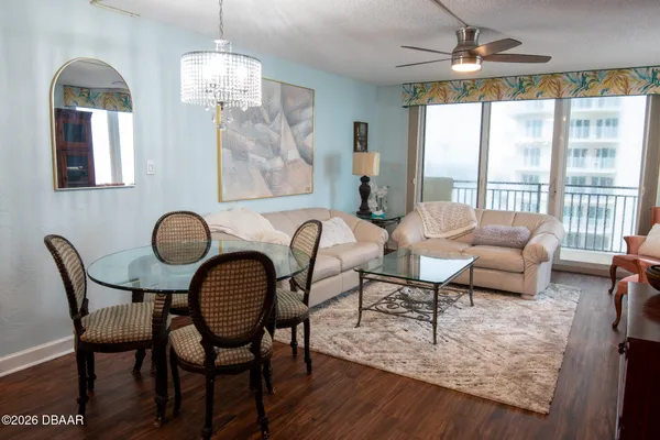 a view of a dining room with furniture wooden floor and chandelier