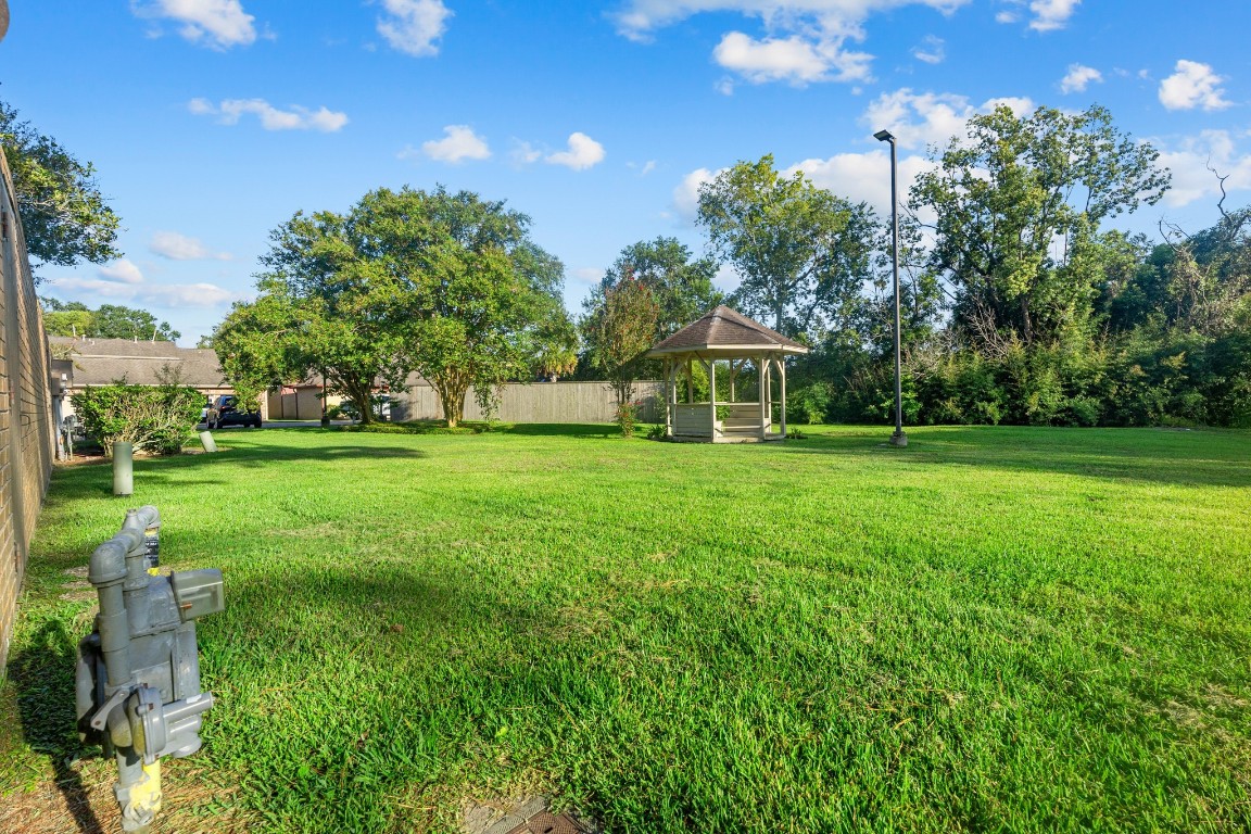 304 East Adoue Street Alvin, TX 77511 - Photo 11 of 12 a view of a house with a big yard