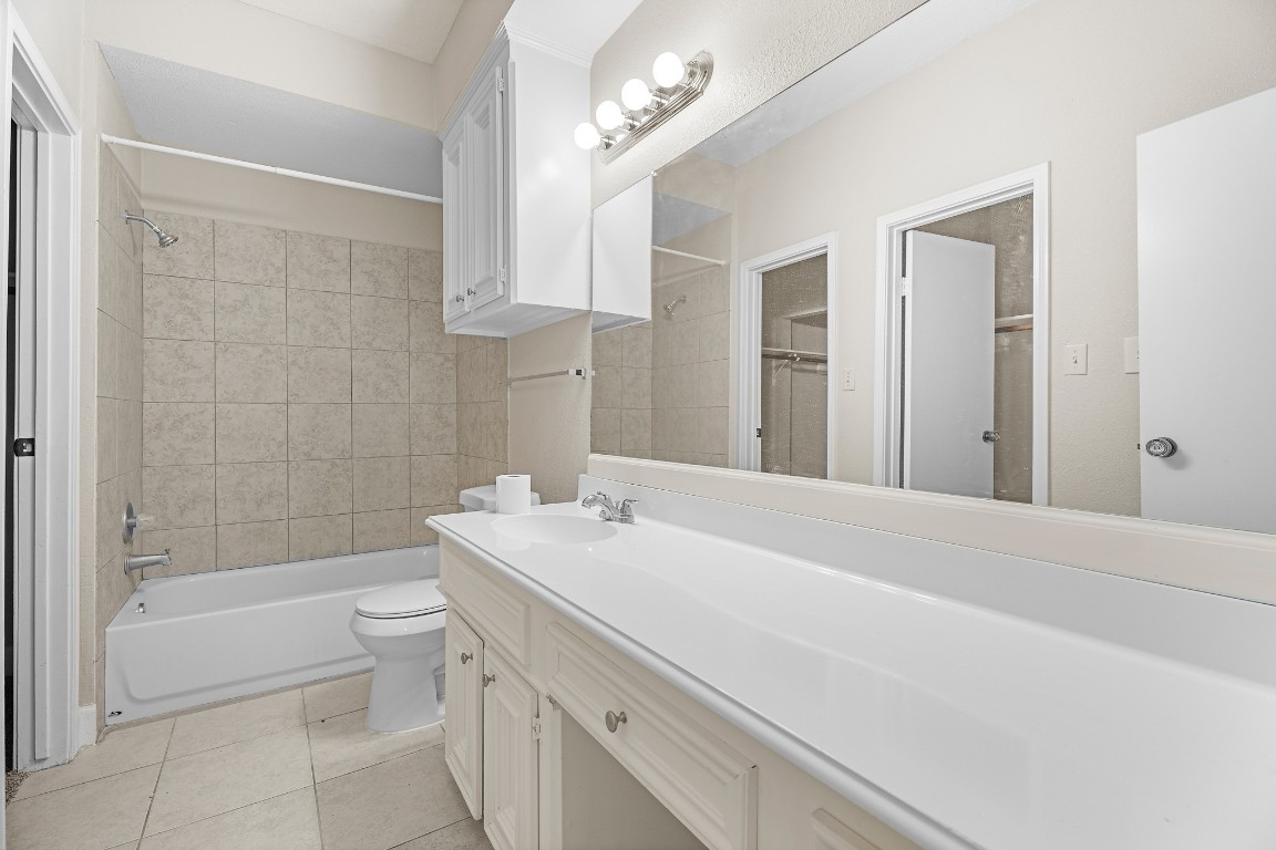 304 East Adoue Street Alvin, TX 77511 - Photo 6 of 12 a bathroom with a sink a toilet and shower