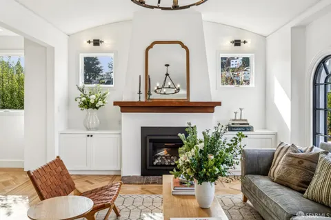 a living room filled with furniture and a floor to ceiling window