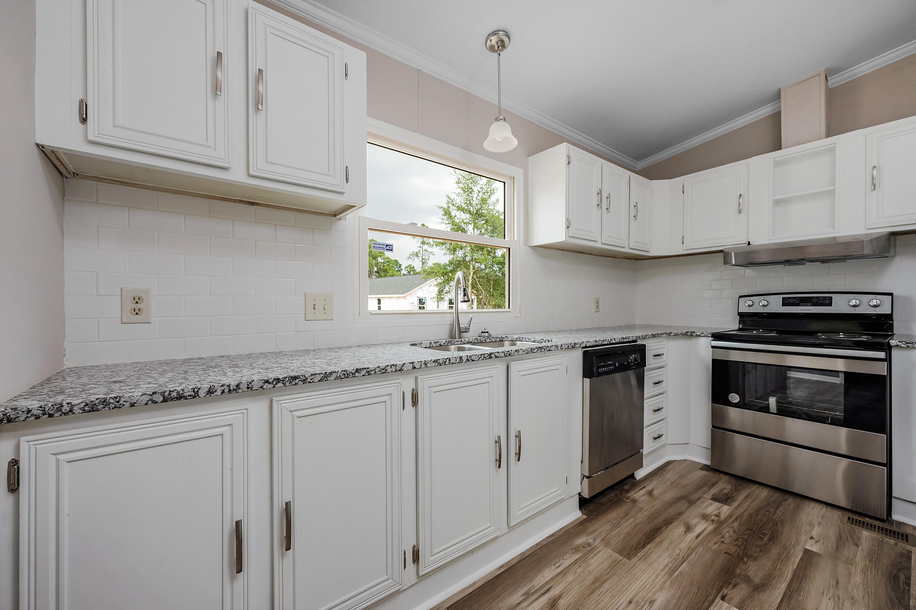 4625 Canary Way Crestview, FL 32539 - Photo 1 of 40 a kitchen with granite countertop cabinets stainless steel appliances and a window