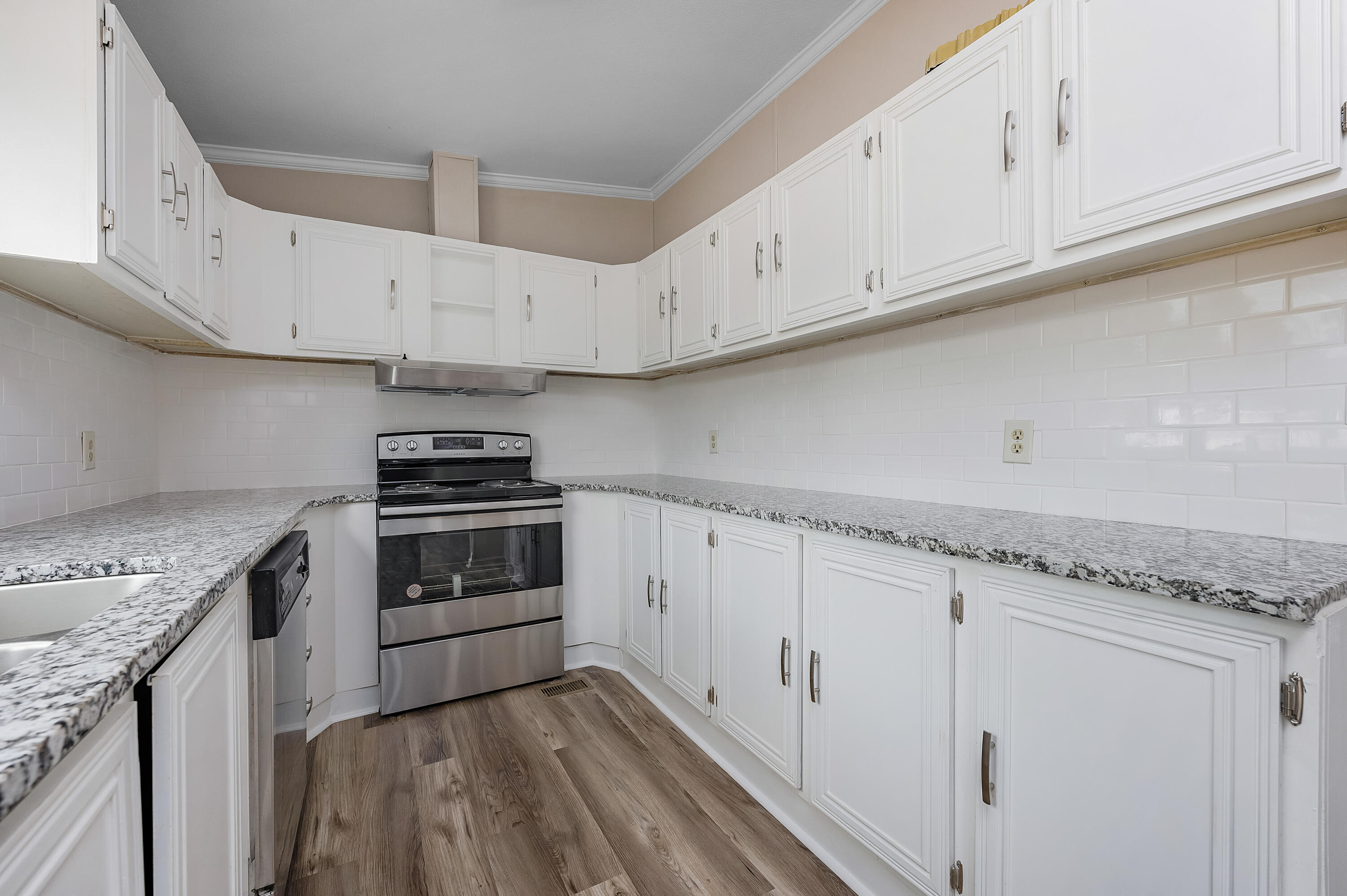 4625 Canary Way Crestview, FL 32539 - Photo 11 of 40 a kitchen with granite countertop a stove and a sink