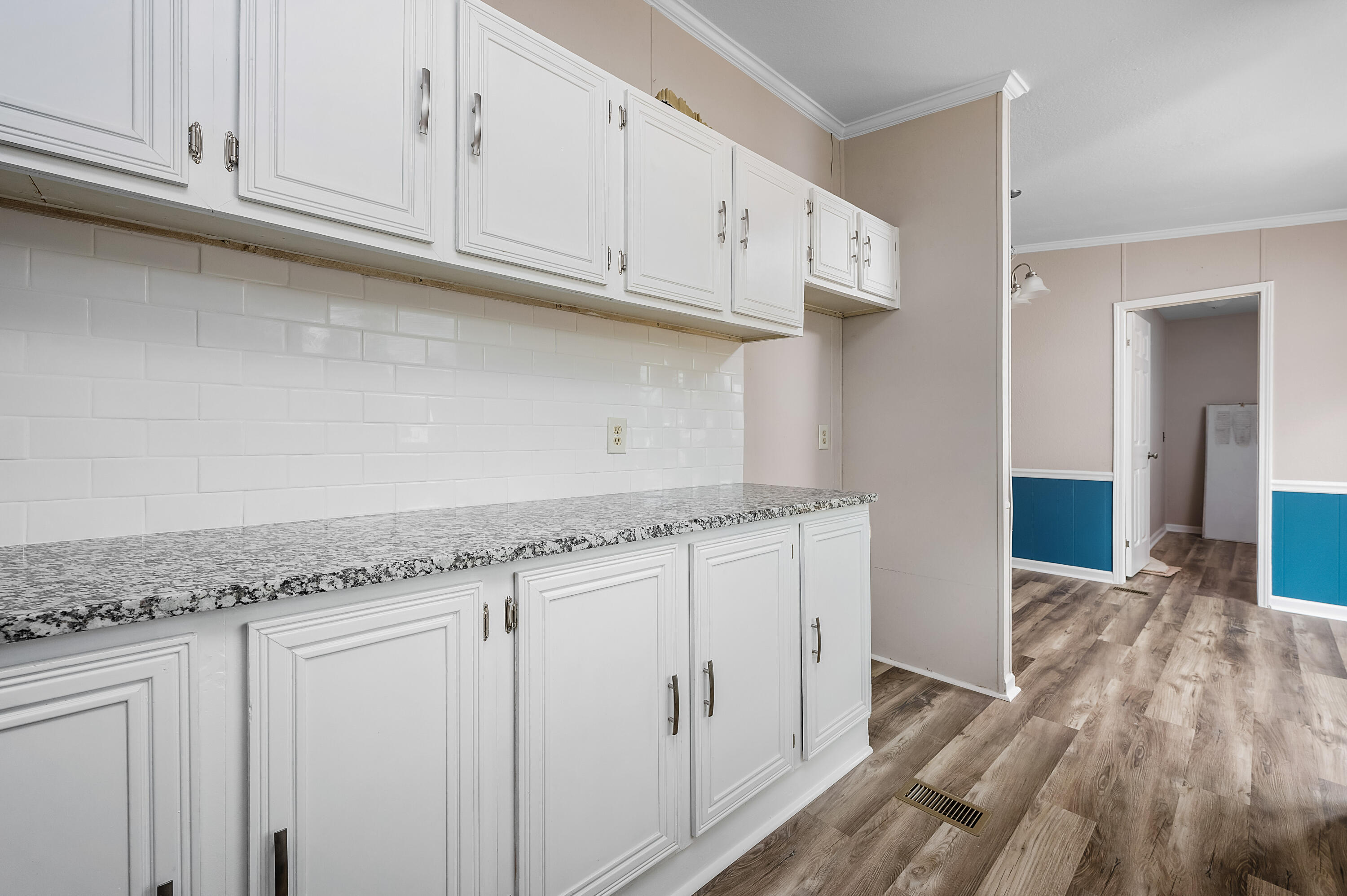 4625 Canary Way Crestview, FL 32539 - Photo 13 of 40 a kitchen with granite countertop white cabinets and a sink
