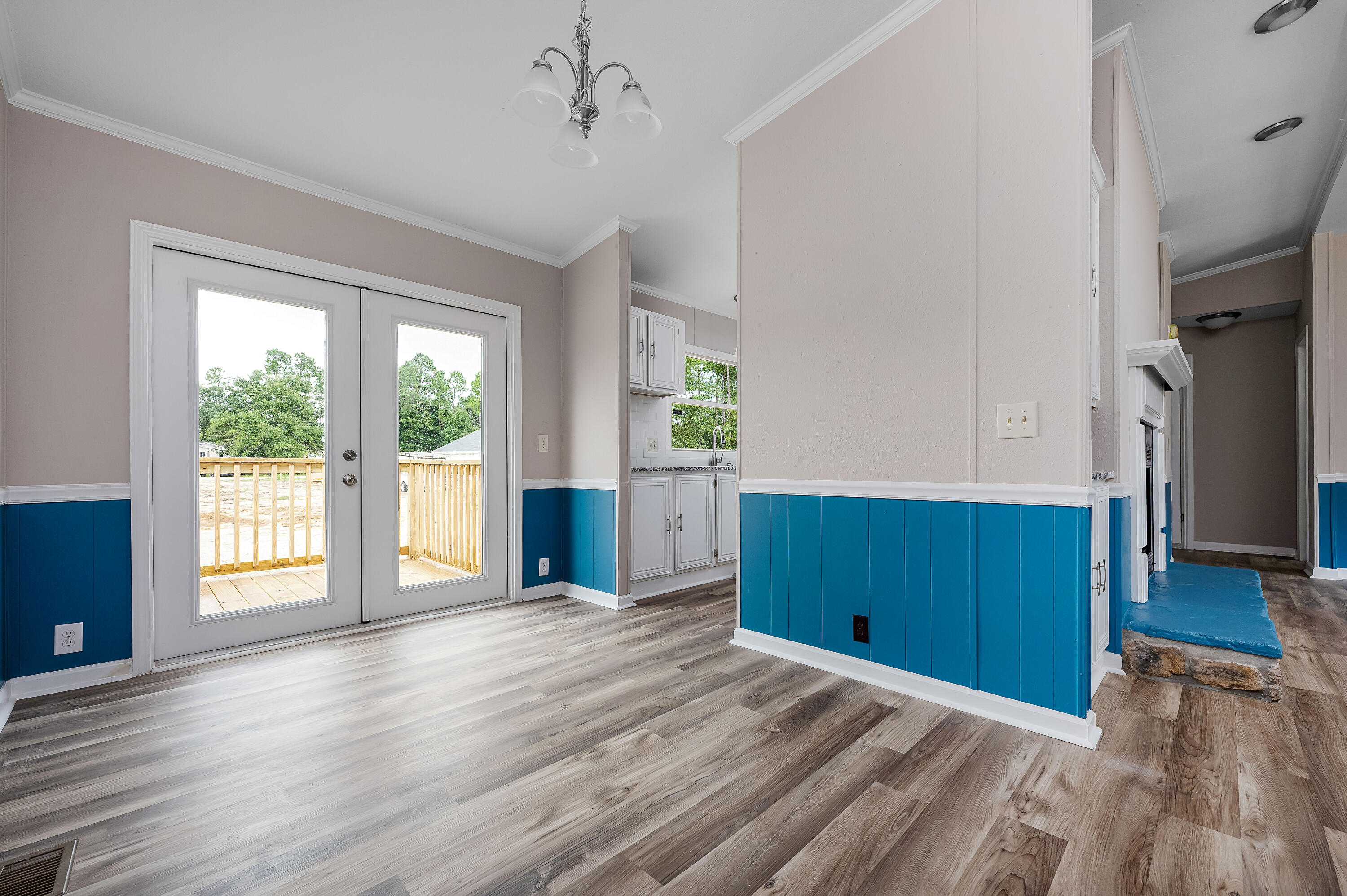 4625 Canary Way Crestview, FL 32539 - Photo 15 of 40 a view of an empty room with a window and wooden floor