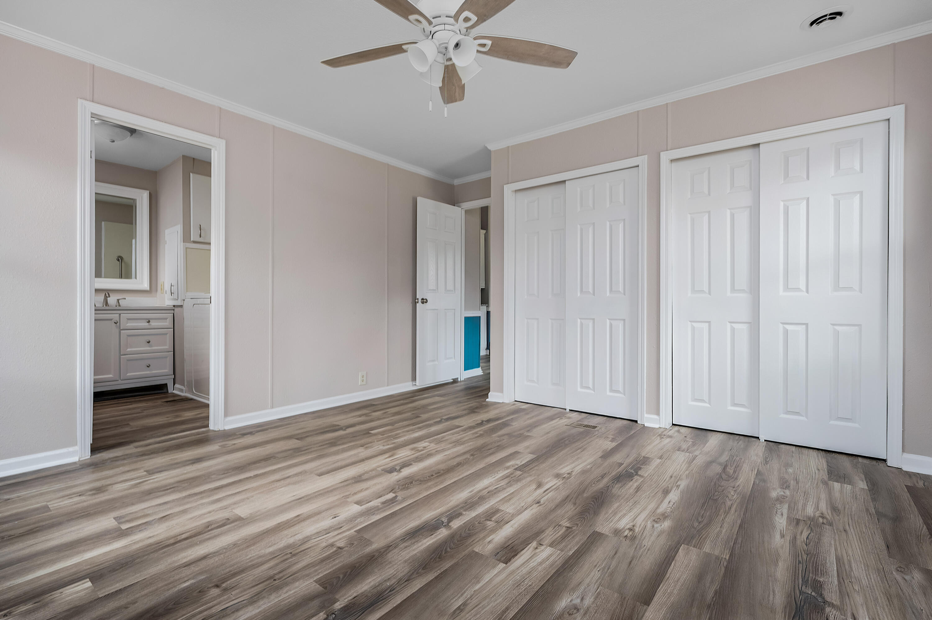 4625 Canary Way Crestview, FL 32539 - Photo 20 of 40 a view of an empty room with wooden floor