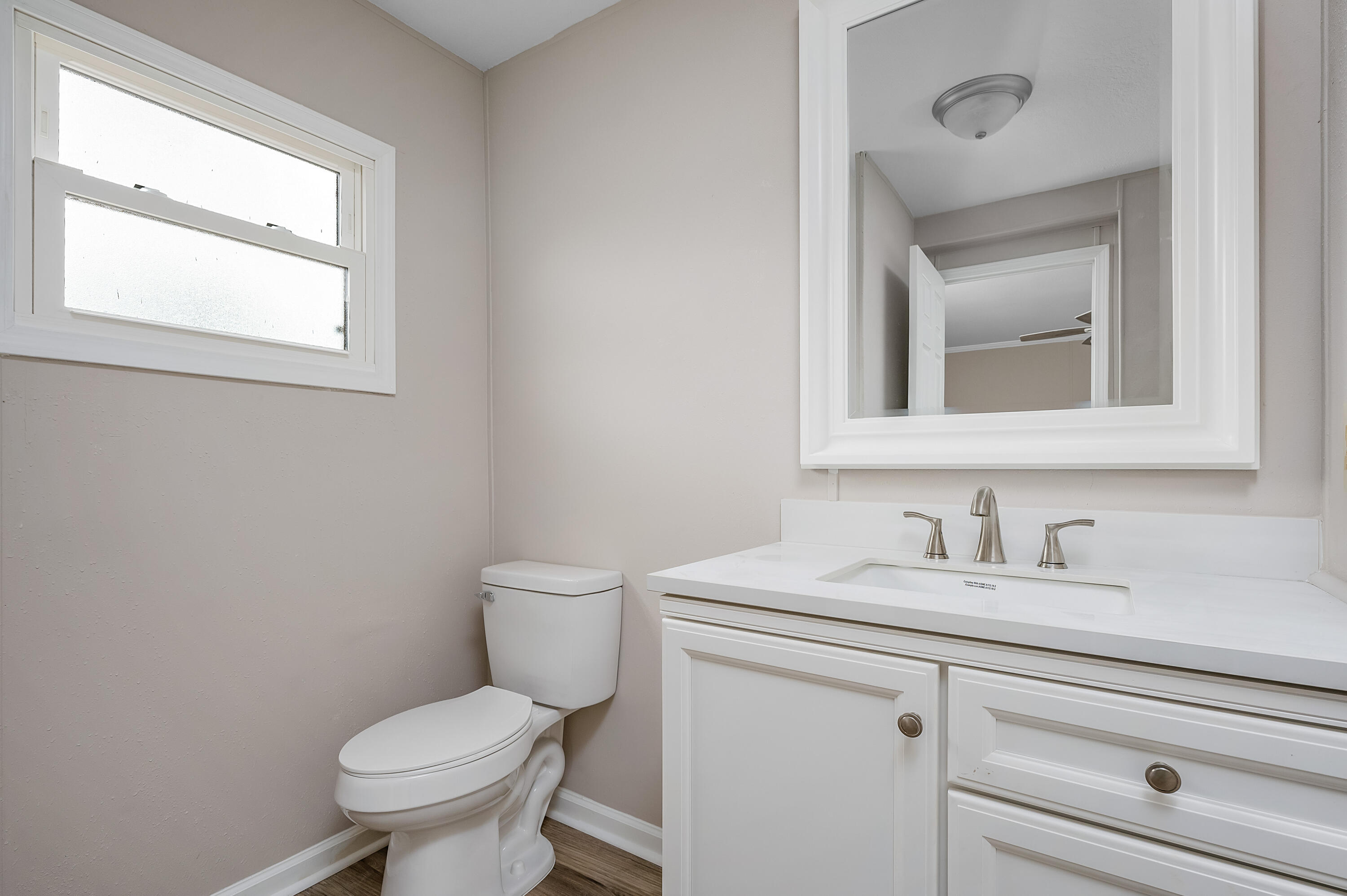 4625 Canary Way Crestview, FL 32539 - Photo 23 of 40 a bathroom with a toilet sink and mirror