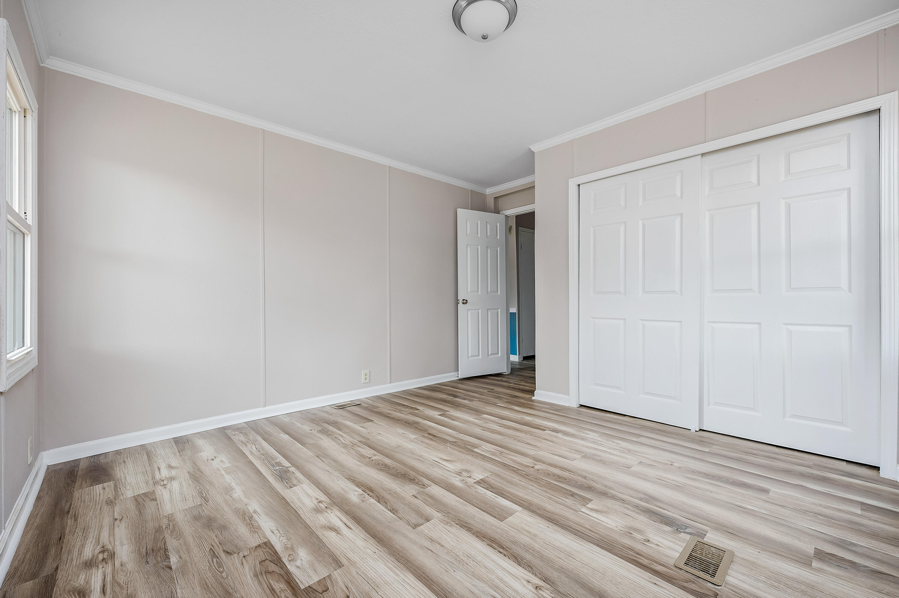4625 Canary Way Crestview, FL 32539 - Photo 27 of 40 a view of an empty room with wooden floor