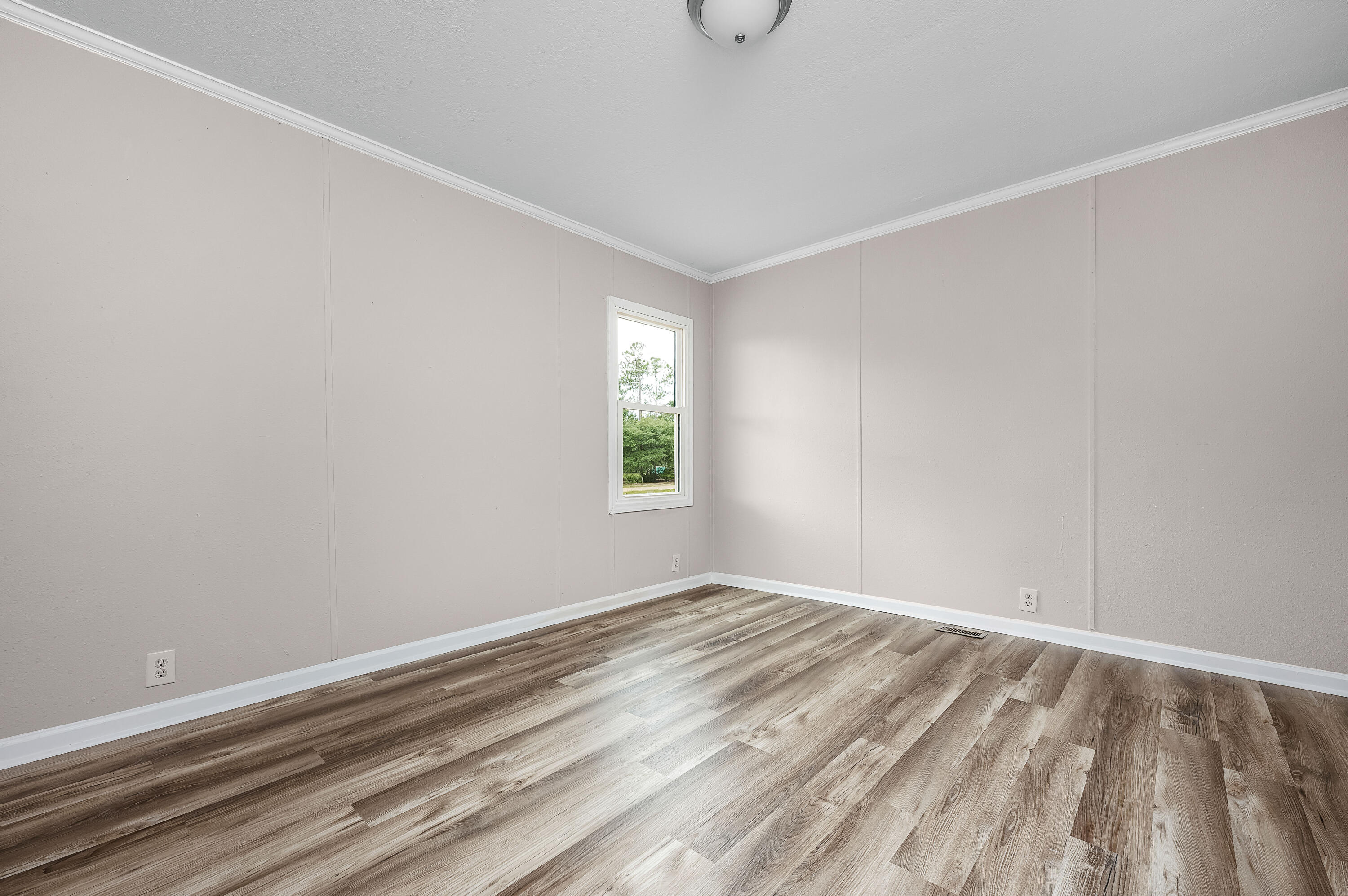 4625 Canary Way Crestview, FL 32539 - Photo 28 of 40 a view of room with window and hardwood floor