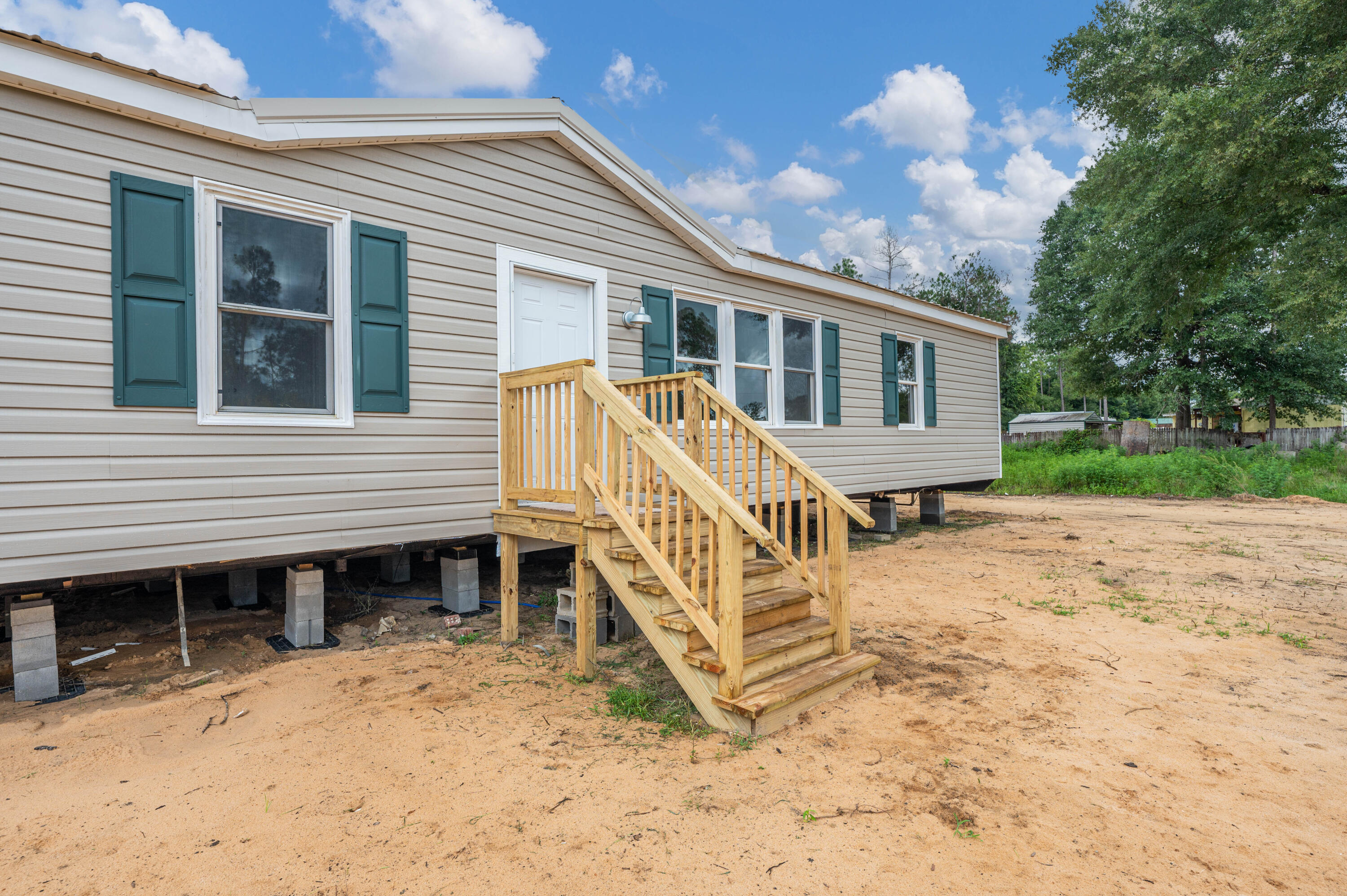 4625 Canary Way Crestview, FL 32539 - Photo 3 of 40 a view of a house with a yard and deck