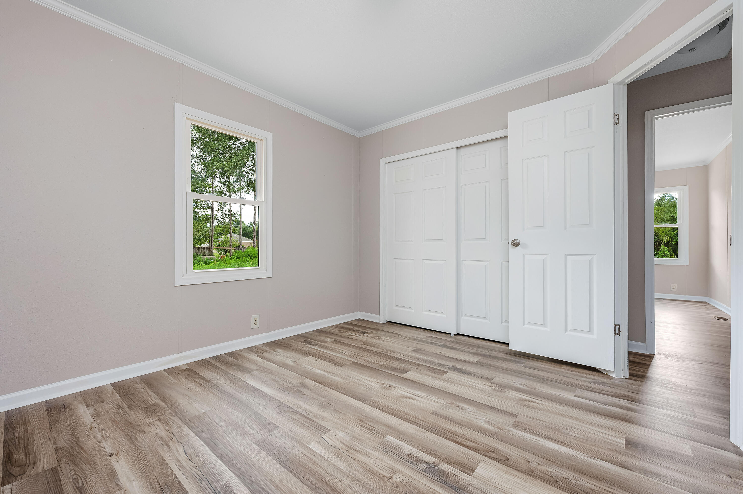 4625 Canary Way Crestview, FL 32539 - Photo 31 of 40 an empty room with wooden floor and windows