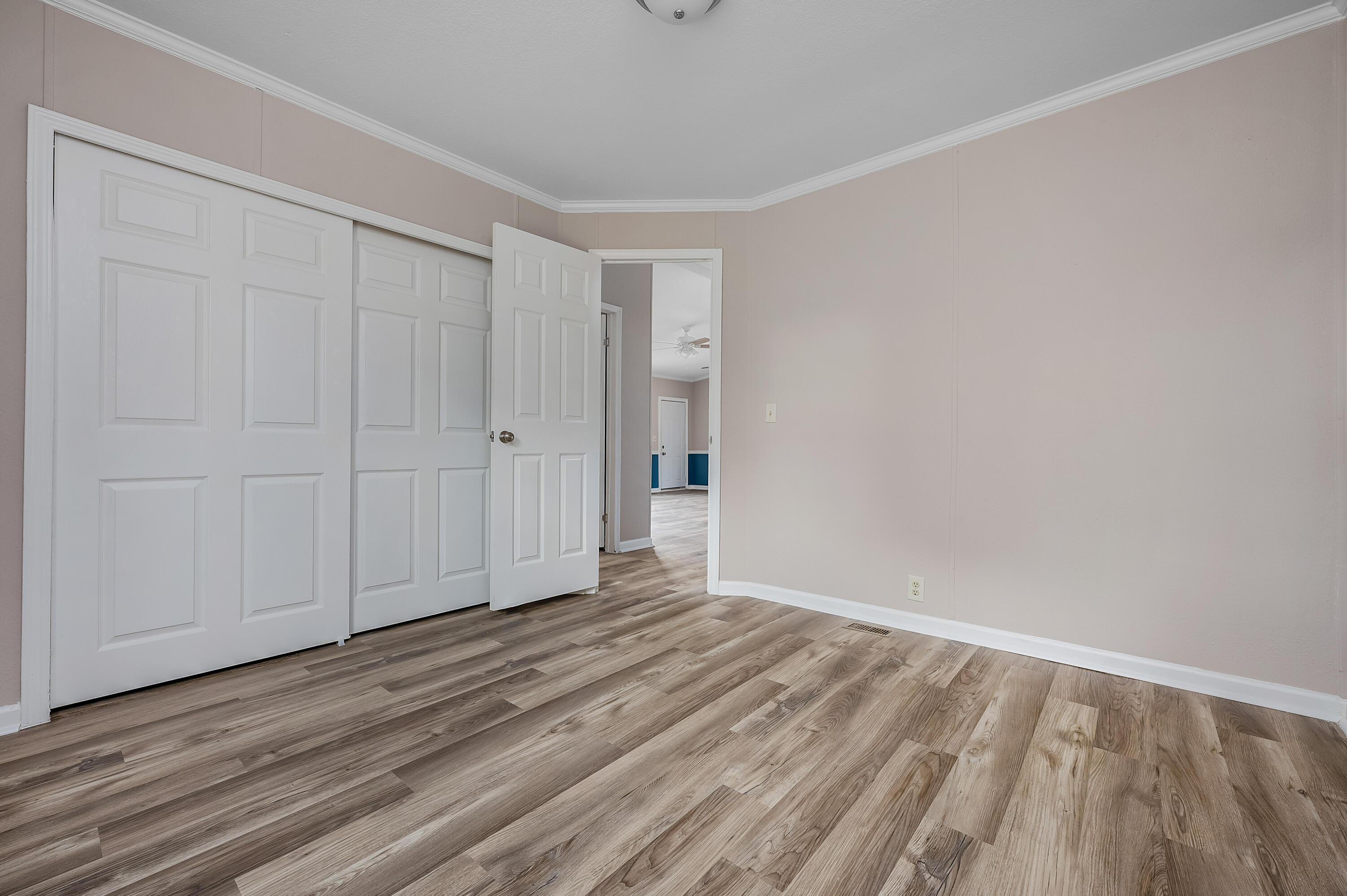 4625 Canary Way Crestview, FL 32539 - Photo 32 of 40 a view of an empty room with wooden floor