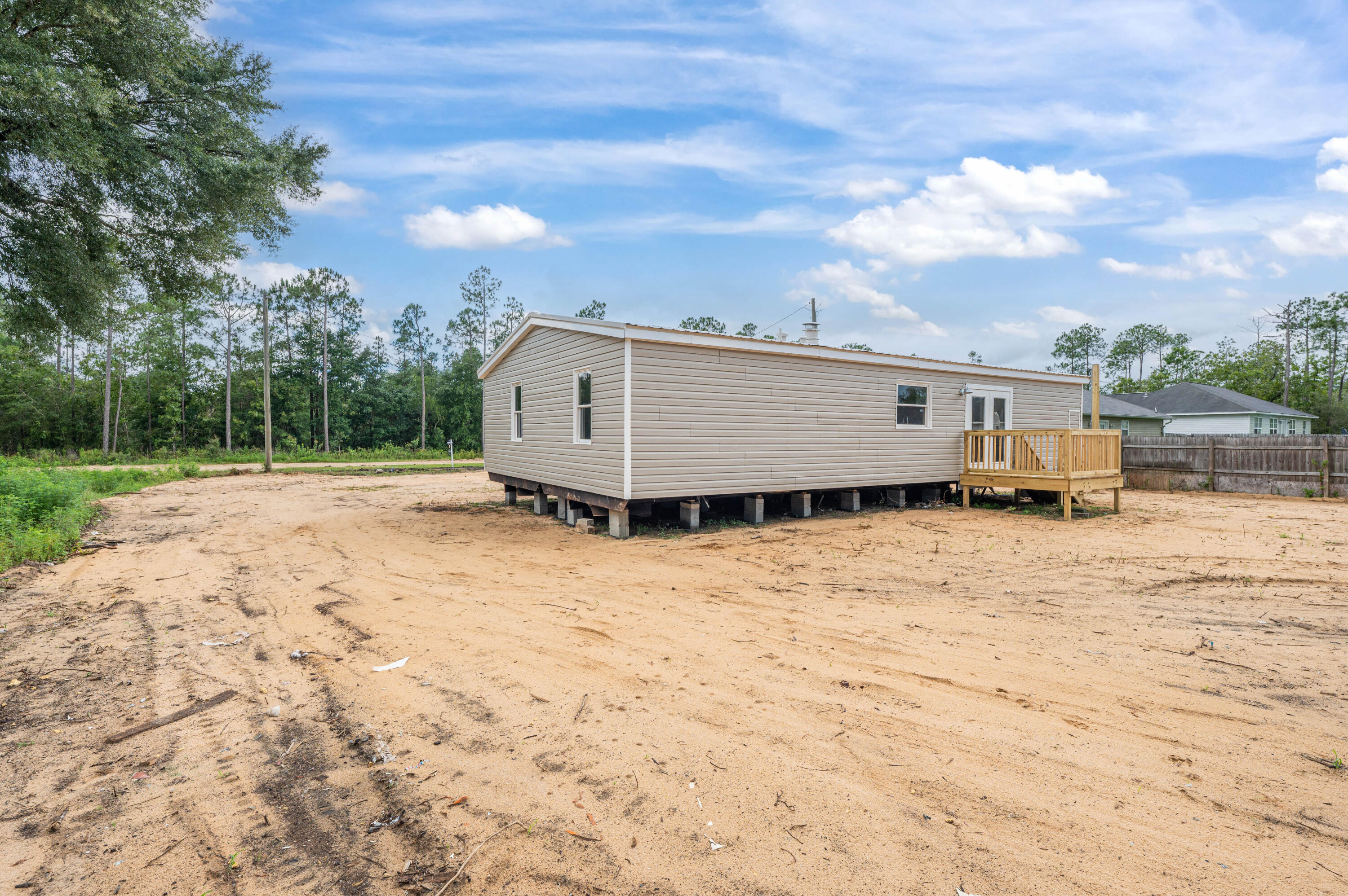 4625 Canary Way Crestview, FL 32539 - Photo 37 of 40 a view of a backyard with wooden fence and a bench
