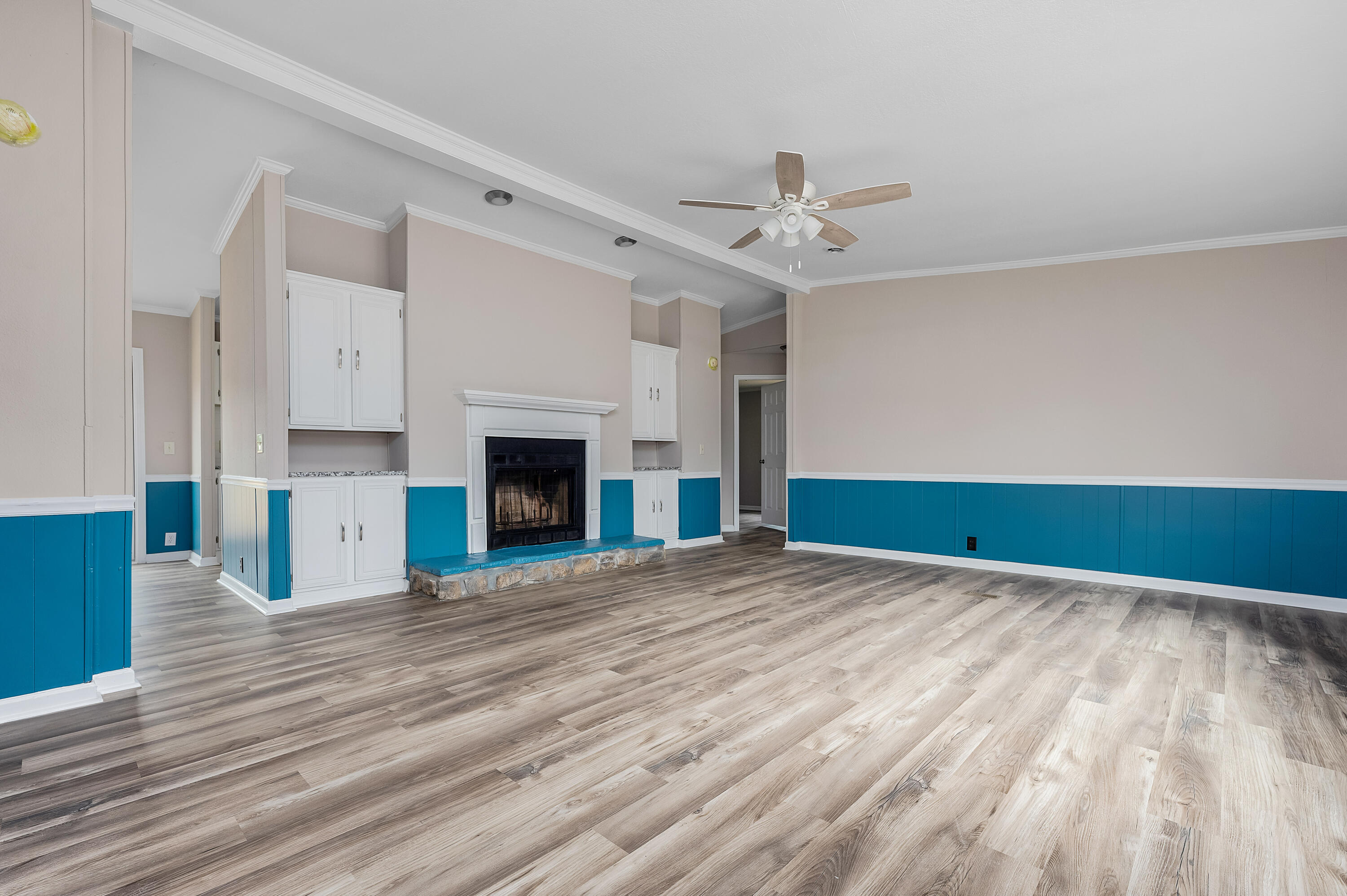 4625 Canary Way Crestview, FL 32539 - Photo 5 of 40 a view of empty room with wooden floor and fireplace