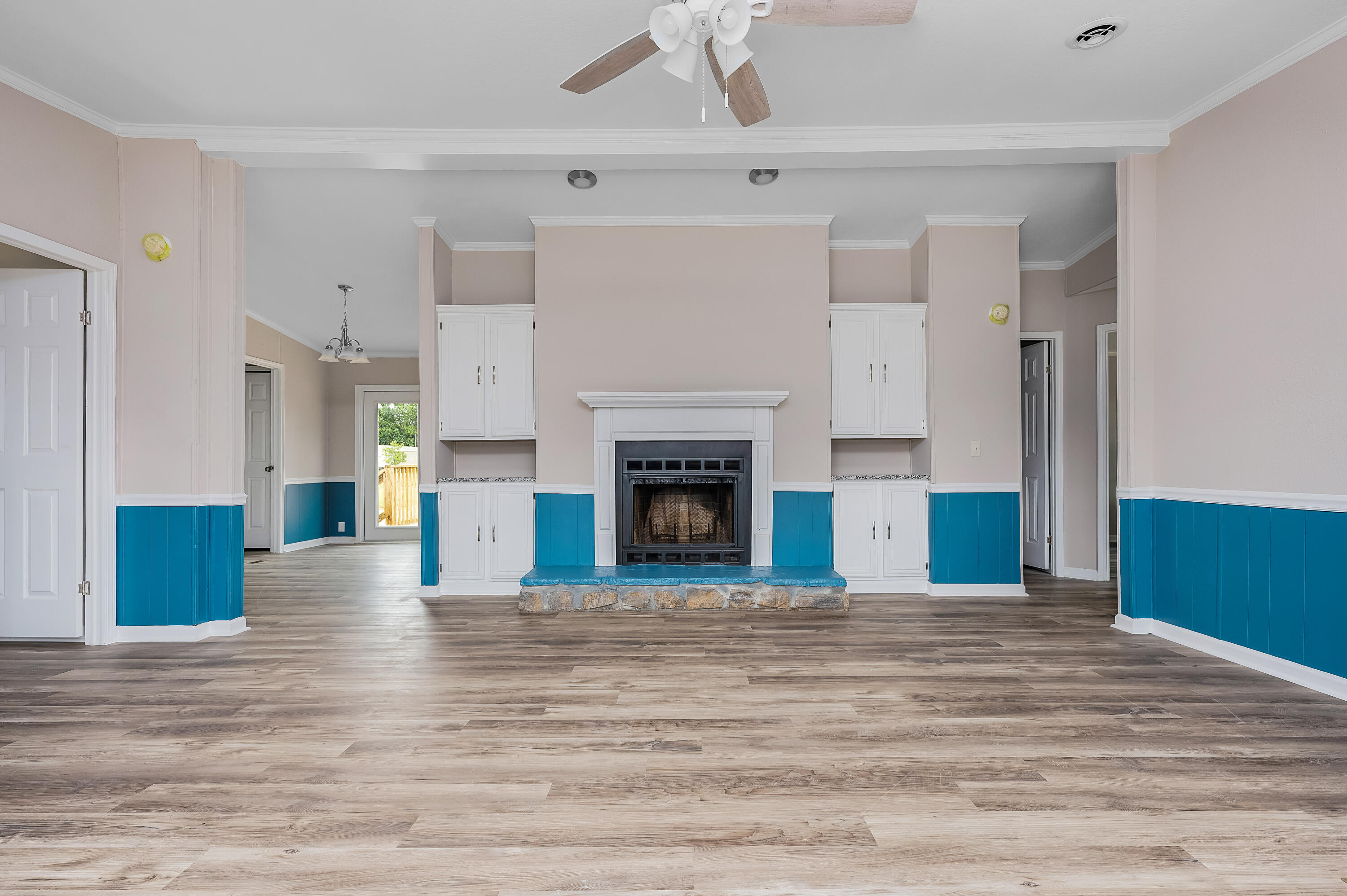 4625 Canary Way Crestview, FL 32539 - Photo 6 of 40 a view of empty room with wooden floor and fireplace