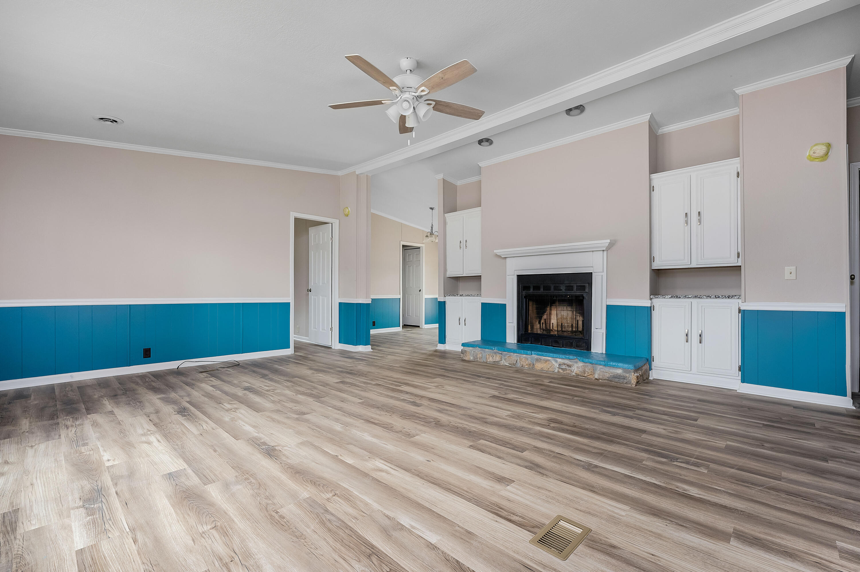 4625 Canary Way Crestview, FL 32539 - Photo 8 of 40 a view of empty room with wooden floor and fireplace