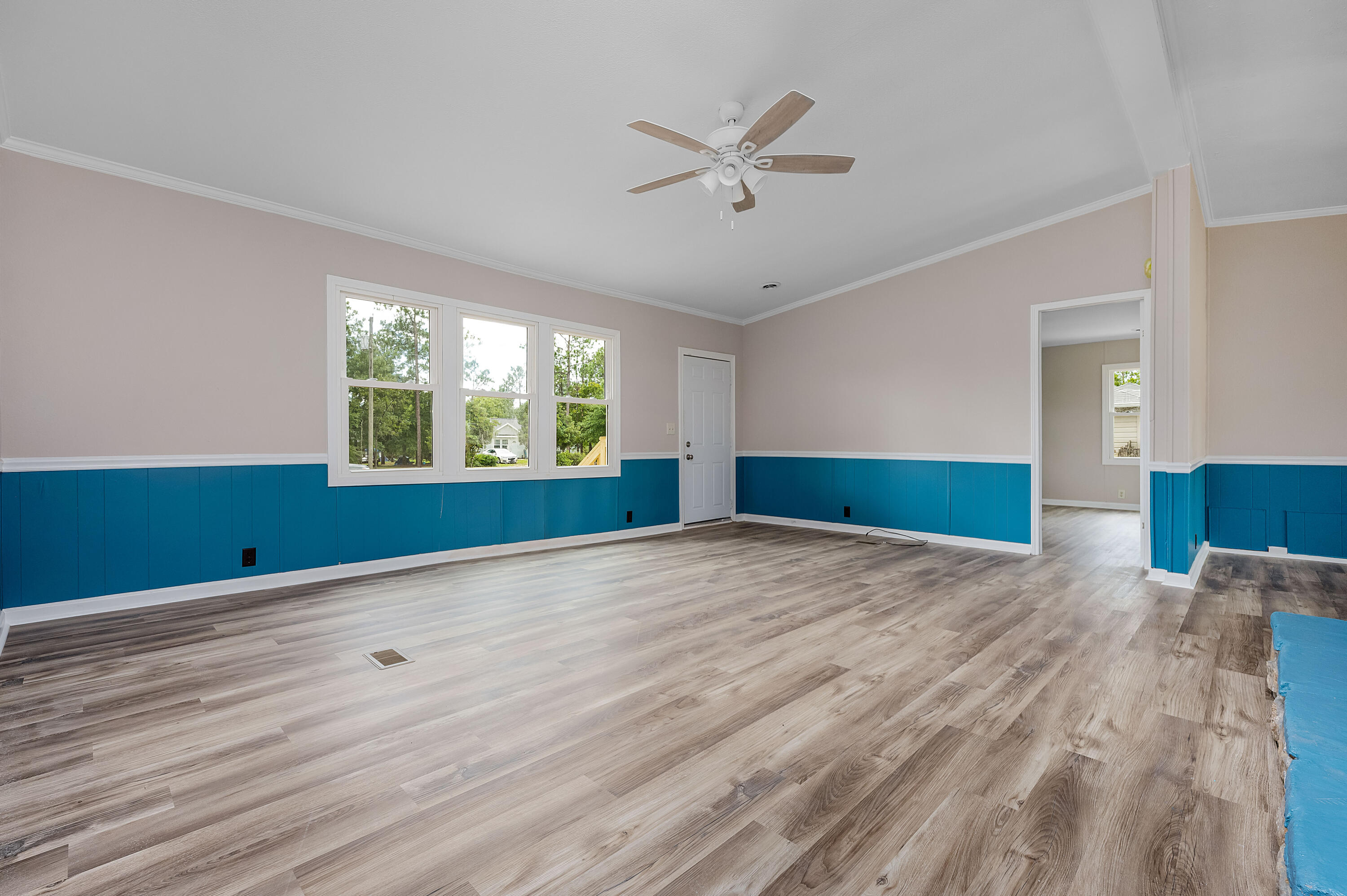 4625 Canary Way Crestview, FL 32539 - Photo 9 of 40 a view of empty room with wooden floor and fan