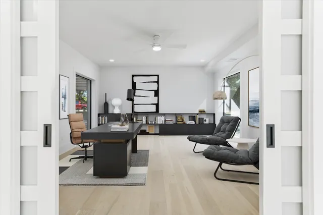 a living room with furniture and a wooden floor
