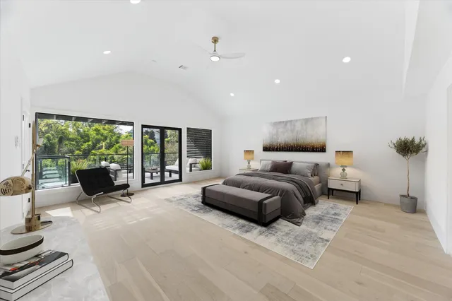 a bedroom with furniture and large windows
