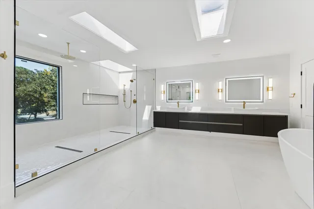 a large white kitchen with a large window