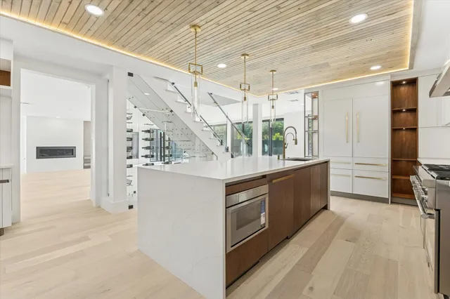 a view of kitchen with stainless steel appliances granite countertop lots of counter top space