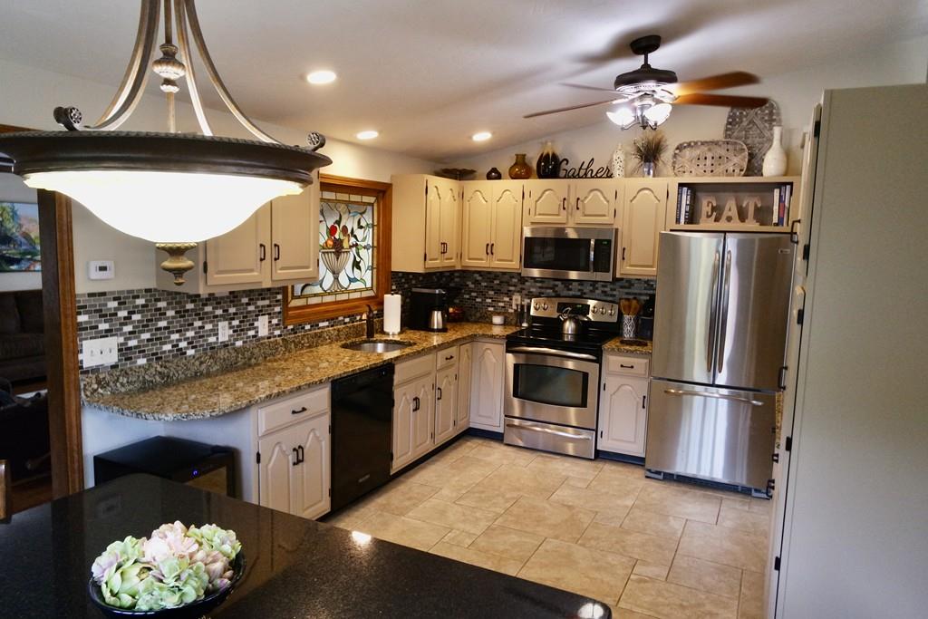 6 Crestlan Drive Worcester, MA 01604 - Photo 14 of 41 a kitchen with stainless steel appliances a stove a refrigerator and cabinets