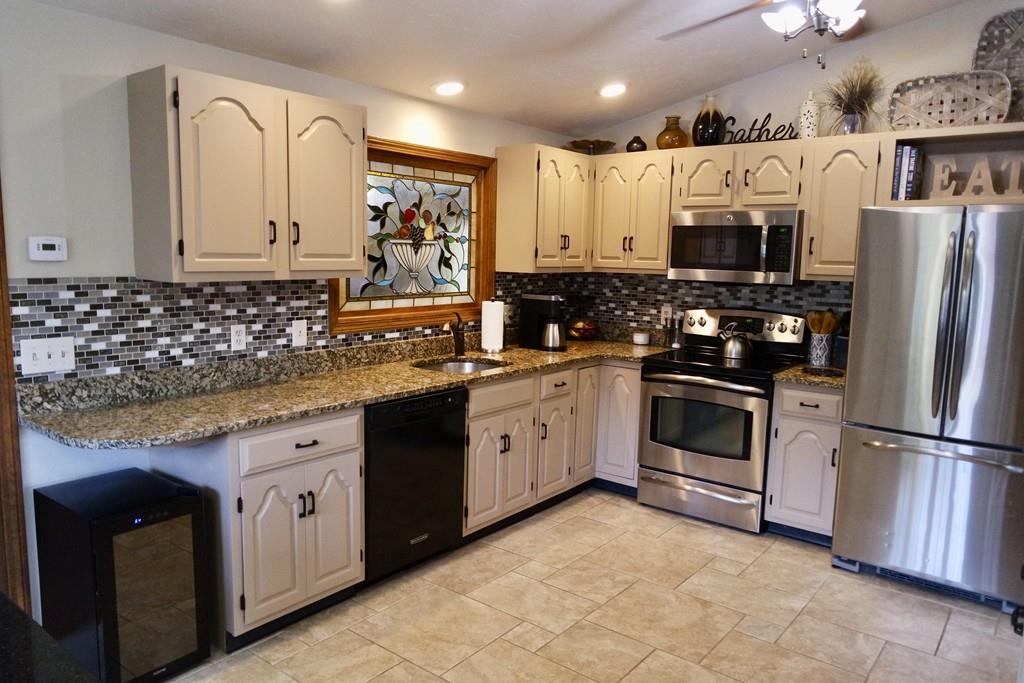 6 Crestlan Drive Worcester, MA 01604 - Photo 15 of 41 a kitchen with stainless steel appliances granite countertop a refrigerator sink and cabinets