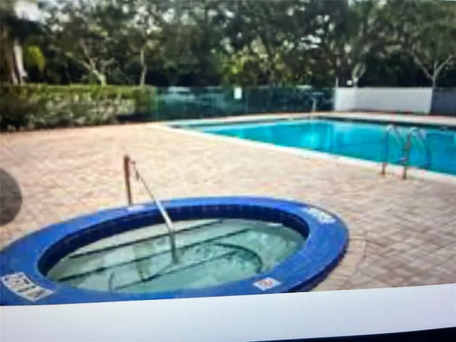 a view of swimming pool with a yard