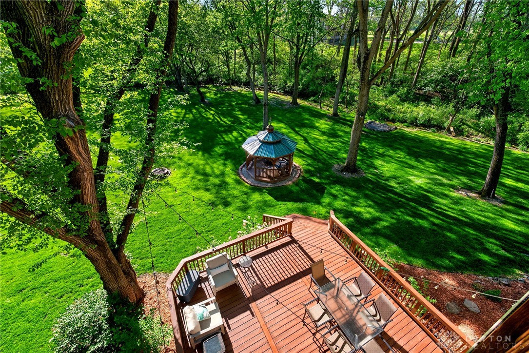 330 South Alpha Bellbrook Road Bellbrook, OH 45305 - Photo 39 of 87 An inviting deck overlooks a lush backyard featuring a charming gazebo, perfect for outdoor living.