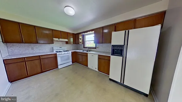 a kitchen with stainless steel appliances granite countertop a refrigerator sink and cabinets