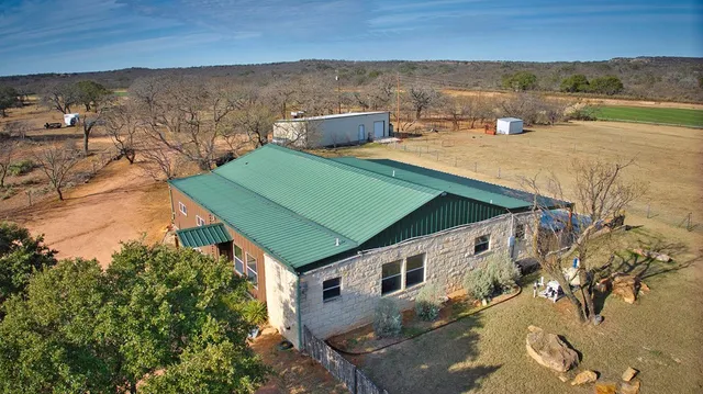 a view of a terrace with chairs and an umbrella