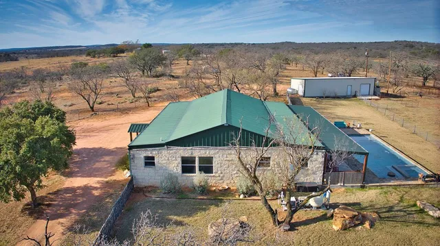 a view of a backyard with sitting area