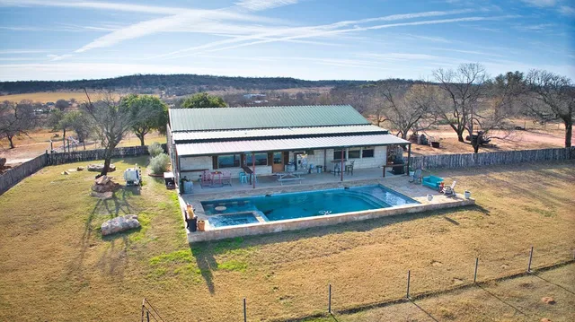 a view of kitchen with furniture and a swimming pool