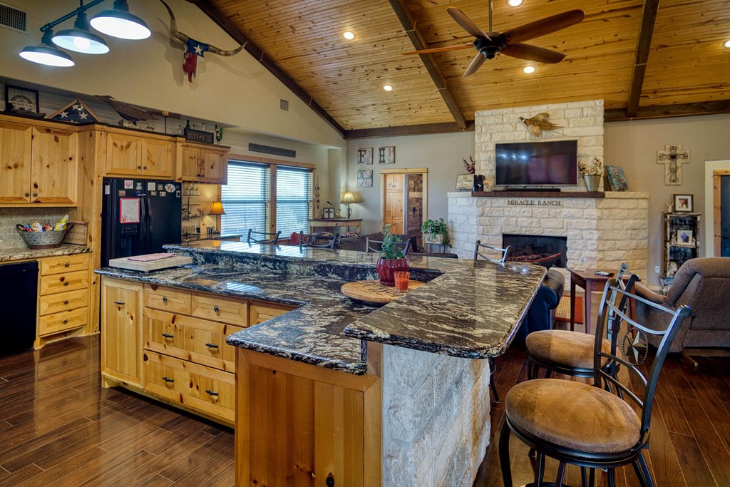 6446 Blackjack Road Fredonia, TX 76842 - Photo 26 of 52 a living room with fireplace furniture and a flat screen tv