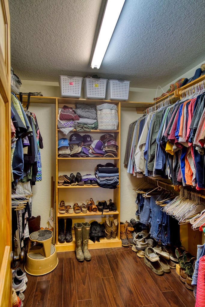 6446 Blackjack Road Fredonia, TX 76842 - Photo 43 of 52 a view of walk in closet with clothes and shoes